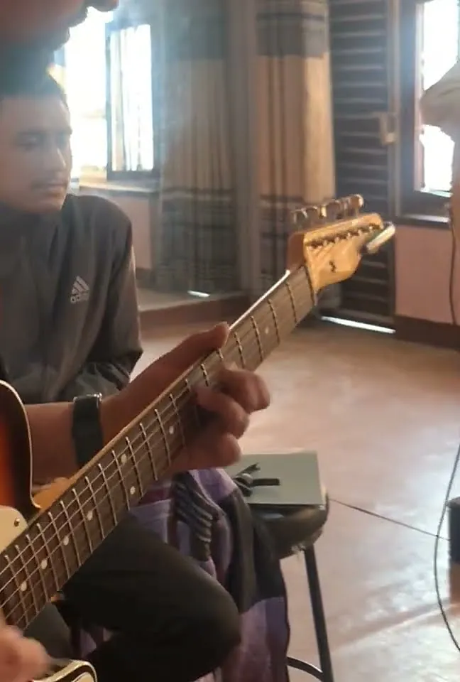Students jamming on electric guitars