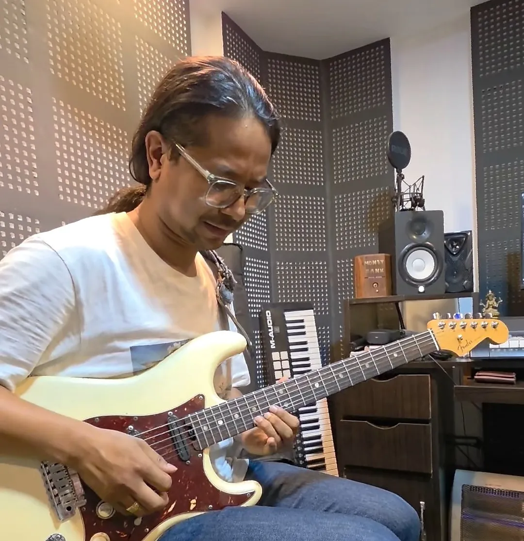 A guitarist playing electric guitar at ECA Academy