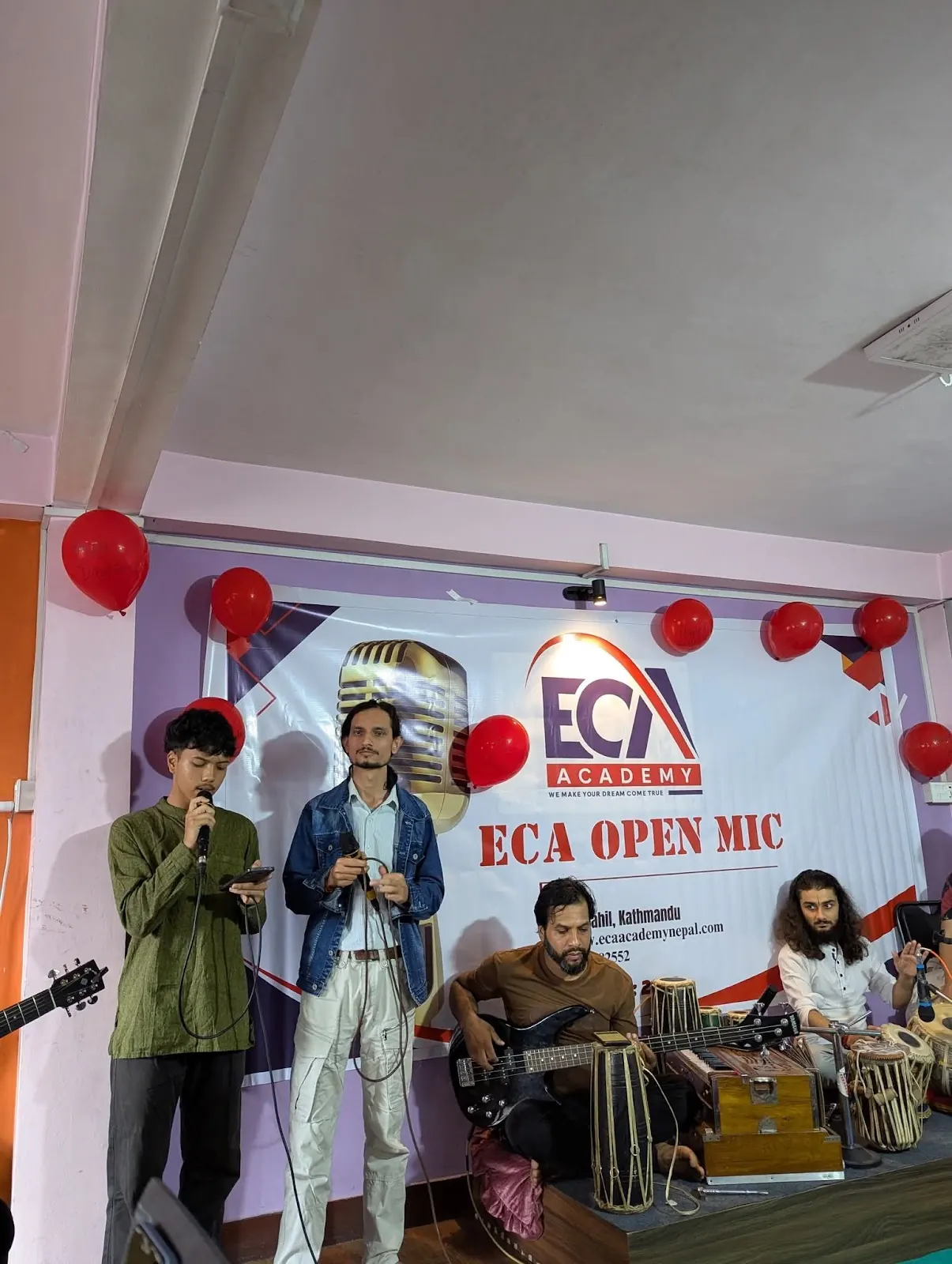 Students performing with guitars at ECA Open Mic